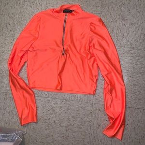 Bright orange disco zip up long sleeve crop top